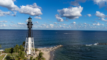 Florida lighthouse at the beach with bright skies.