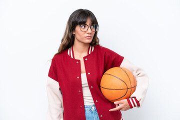 Young caucasian woman playing basketball isolated on white background looking to the side