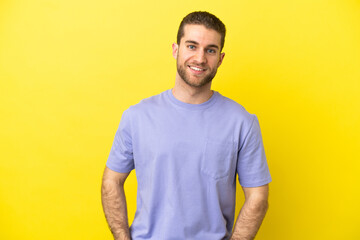 Fototapeta premium Handsome blonde man over isolated yellow background laughing