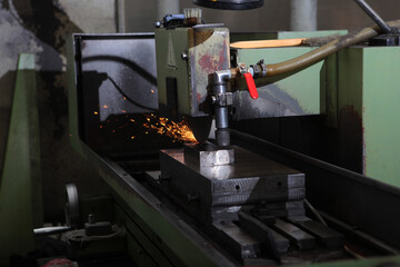 Sparks on the machine. Grinding of metal parts for the production of bearings. Manufacture of bearings.High temperatures. The concept of the industrial industry.