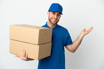 Delivery man over isolated white background extending hands to the side for inviting to come