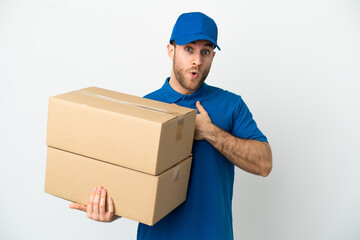 Delivery man over isolated white background surprised and shocked while looking right