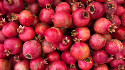 Beautiful background of ripe red pomegranates.