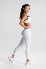 Fitness woman. Athletic girl on the gray background - 536814708