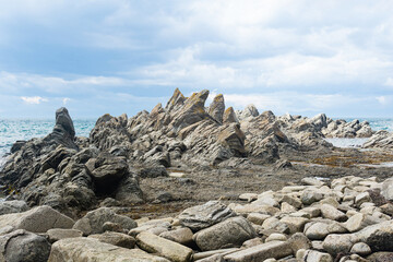 basalt rocks on the sea coast, Cape Stolbchaty on Kunashir Island