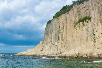 coast of Kunashir Island with columnar basalt cliff, Cape Stolbchaty