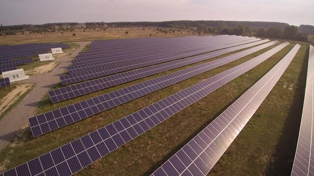 Rows of sun panels built at electrical substation in field