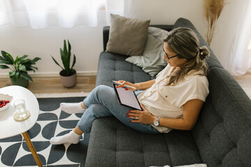 Adult woman using tablet at home