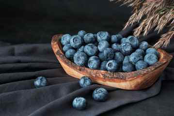 Blueberry in  wooden bawl Ripe and juicy fresh picked blueberries closeup
