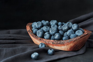 Blueberry in  wooden bawl Ripe and juicy fresh picked blueberries closeup