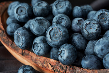 Blueberry in  wooden bawl Ripe and juicy fresh picked blueberries closeup