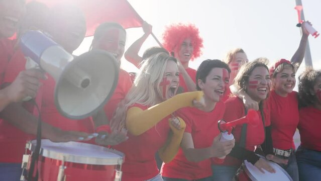 Crowd of football supporter fans screaming and cheering watching sport team match at stadium - World championship concept