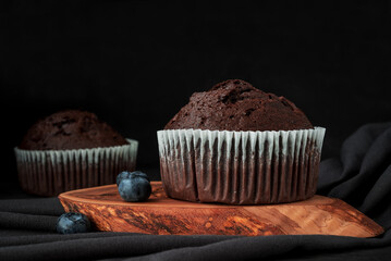 chocolate muffin on a dark surface.