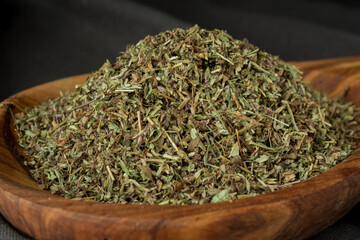 Dried chopped provence herbs in a wooden  bowl