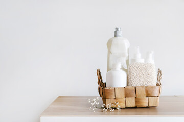 Fototapeta na wymiar wicker basket with cleaning supplies on shelf indoors