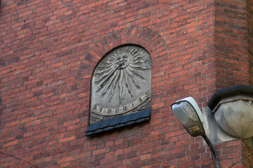 Historical antique vertical sundial on the facade of the church of St. Boniface