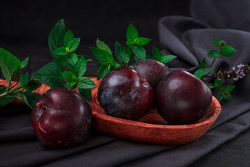 Fresh purple plum  on black background