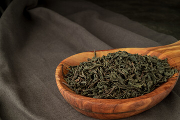 Full leaf loose green,black tea in wooden spoon