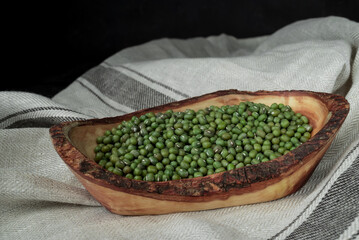 Raw mung bean in the wooden spoon
