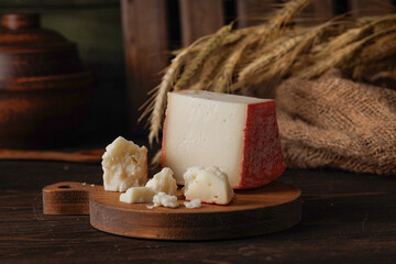 fontina cheese is lying on the village table. horizontal frame