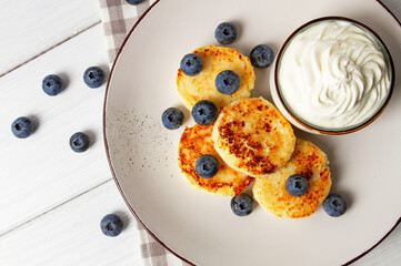 Cottage cheese pancakes , with blueberries ,breakfast , on a white wooden table, no people, top...