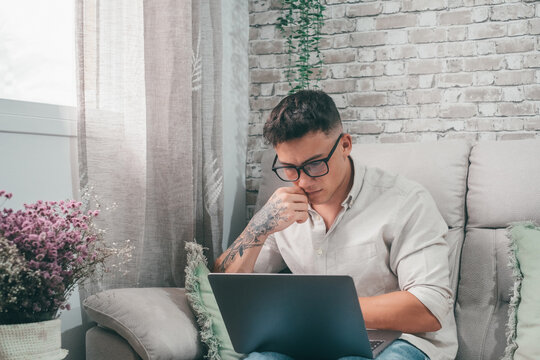 One Serious And Focused Young Entrepreneur Working Hard And Analyzing Market At Home. Teenager Boy Studying And Doing Homework For School Alone..