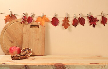 Empty kitchen wooden table for product display and maple leaves, minimal autumn concept, creative autumn composition with screen banner. Happy Thanksgiving and greeting card, selective focus