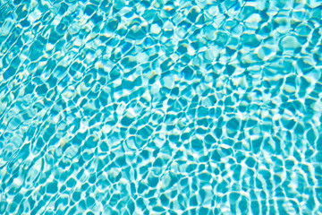 blue color background of swimming pool water with ripples. concept of summertime