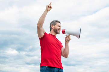 man in red shirt shout in loudspeaker on sky background. big sale