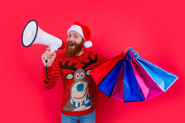 happy new year. happy man announcing about new year sales. man with shopping bag at new year