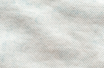 Fototapeta na wymiar Light blue jean fabric. Background macro