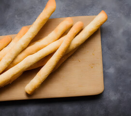 a photo of breadsticks, crusty baked food item, high calorie snack