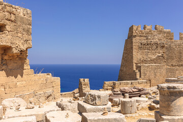 Panoramic view of ruins of ancient city of Lindos on colorful island of Rhodes, Greece. Famous tourist attraction. Ancient temple Greek architecture. High quality photo