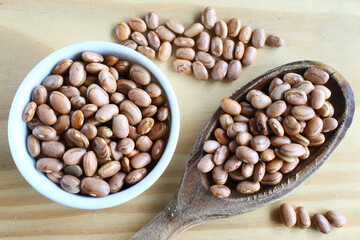 Brazilian beans. Carioca beans in a ramekin and wooden spoon.