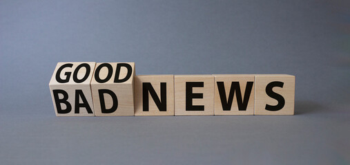 Good news and Bad news symbol. Turned wooden cubes with words Bad news and Good news. Beautiful grey background. Business concept. Copy space