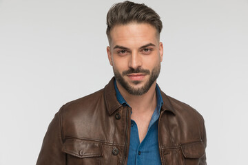 Fototapeta premium portrait of attractive young man with beard smiling in studio