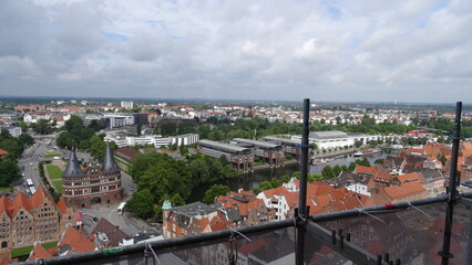 Naklejka na ściany i meble River, a panoramic view of Lübeck, buildings, the holstentor, sky, trees at Lübeck, germany
