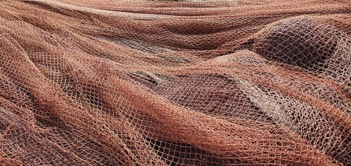 Fishing nets for catching fish in the sea and ocean. Fishing nets on a ship. Texture of fishing nets.