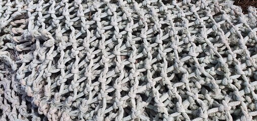 Fishing nets for catching fish in the sea and ocean. Fishing nets on a ship. Texture of fishing nets.