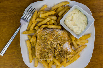 baked haddock  resting on french fries