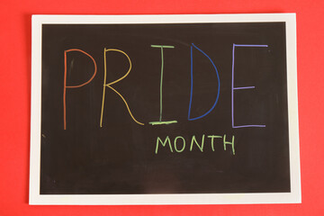 LGBT Pride Month in June. inscription pride on black board