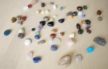 colored stones and minerals lie on the table in daylight. Exhibition of stones, sale, trade, selection. Fair, Good Buy