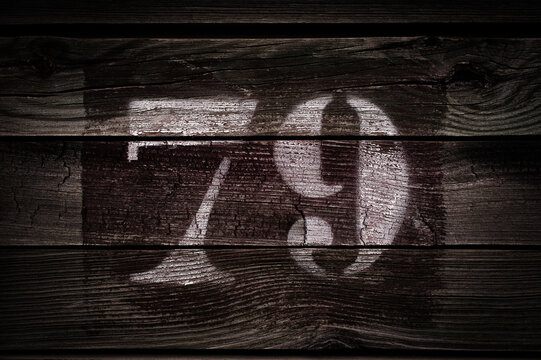 old 79 (seventy-nine) painted on ancient wood plank. background with text