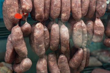 Close-up of raw sausages hanging in butcher shop