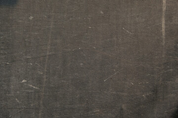 Background of a black awning in close-up. The texture of an old worn tarpaulin. The tent tarpaulin damaged in nature