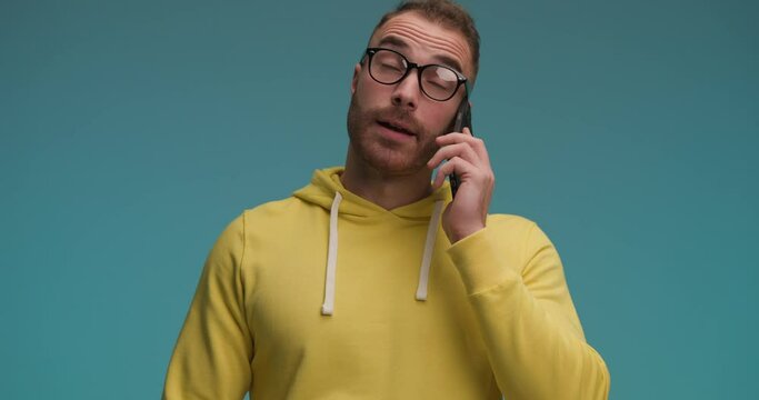 handsome casual man listening to all the yapping and bla bla bla on the phone