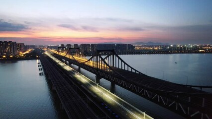 high speed train over qiantang river in hangzhou at sunset
