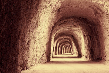 Illuminated Mountain Tunnel in brown tones. The long tunnel for a poster, calendar, post,...