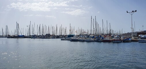 Yachts in the harbor. Yachts in the sea. Yachts in the port. Pier in the sea. Boats, boats and yachts in the parking lot. Seaport in Spain in Torrevieja.