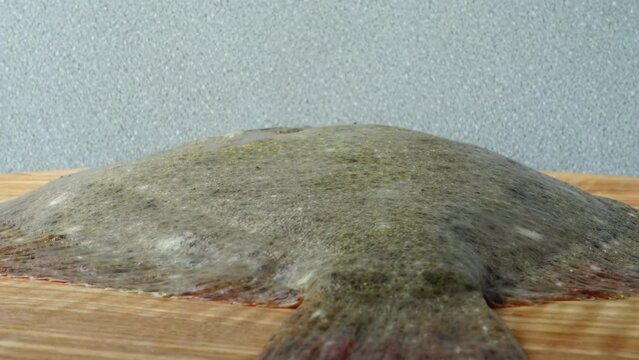 Fish of flatfish on a cutting board.